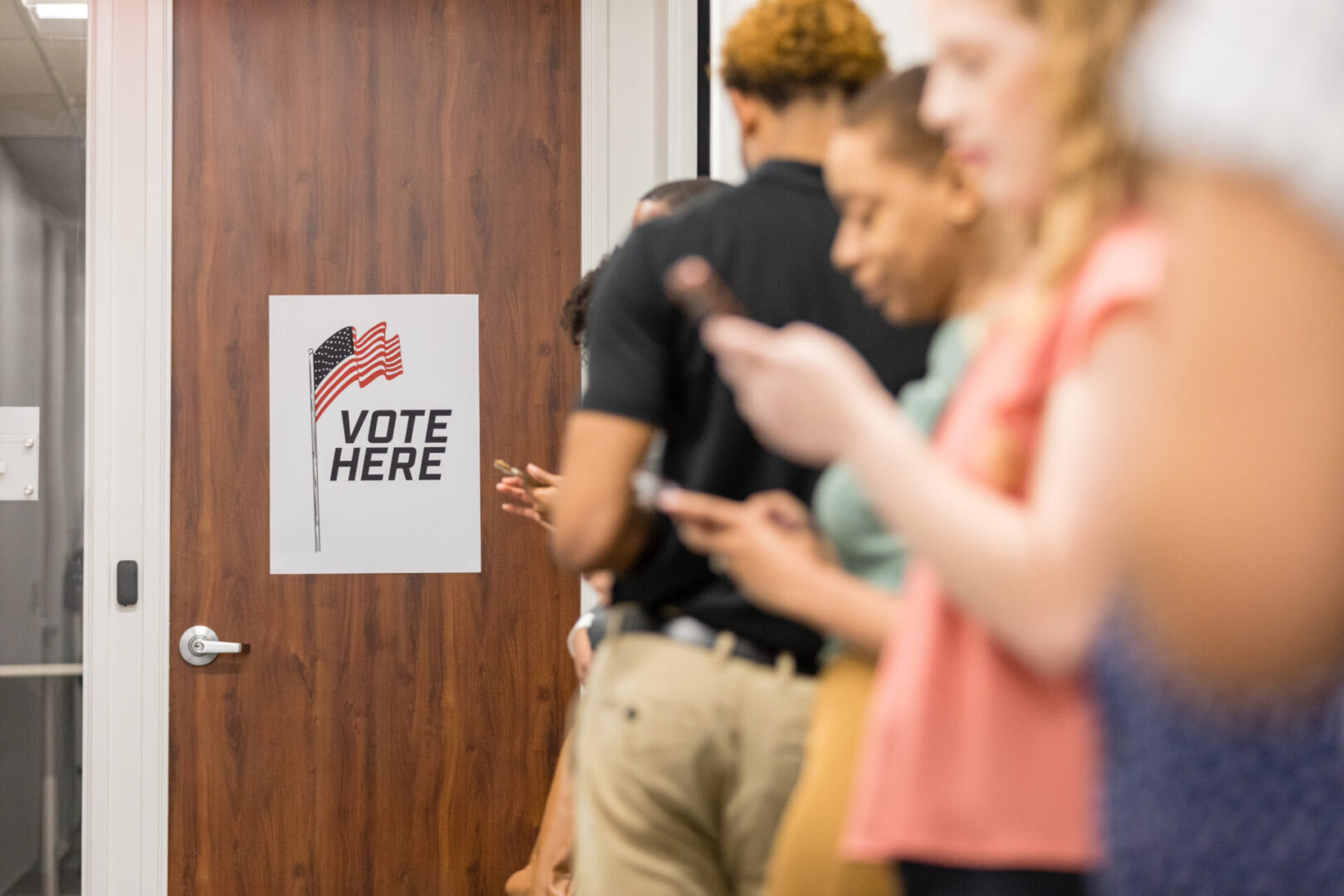 Voters queue near polling station door